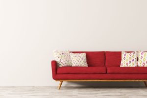 Modern interior of living room with red sofa, white cushions and vase with branch panorama 3d rendering