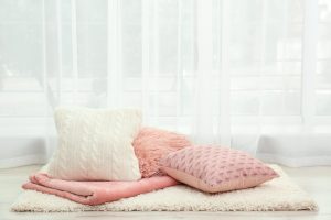Colorful pillows on floor indoors