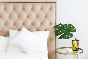 Modern bedroom with table side and pillows and coffee. Closeup