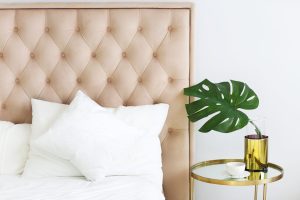 Modern bedroom with table side and pillows and coffee. Closeup